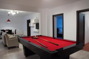 a living room with a pool table in the middle at Apartament Vlad in Turda