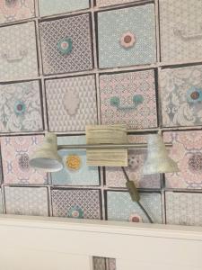 a tile wall with two lights on it at Villa Casa Mia in Balatonlelle +77 photos