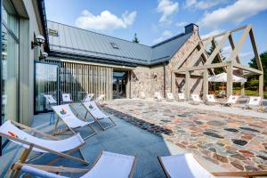 a group of chairs sitting on a patio at Hotel Afrodyta Business & Spa in Radziejowice