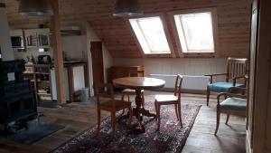 a kitchen with a table and chairs in a room at Lindenhof in Wahrenberg