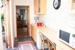 a kitchen with a counter and two chairs in it at Chikanka in Himeville