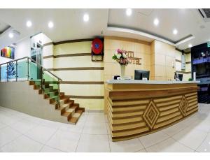a lobby with a counter and stairs in a store at CITI HOTEL @ KL SENTRAL in Kuala Lumpur