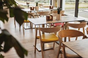 a row of tables and chairs in a restaurant at Pałac Runowo in Runowo Krajeńskie