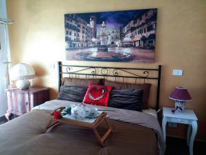 a bedroom with a bed with a large painting on the wall at Le Giare House in Grezzana