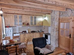 uma cozinha com armários de madeira e uma parede de pedra em Vila Verusa em Veruša
