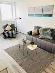 a living room with a couch and a table at Central Apartments in Veszprém