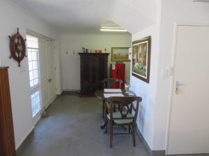 a hallway with a table and chairs in a room at Dawn's Place in Hermanus