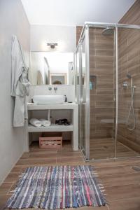 een badkamer met een wastafel en een douche bij Eudaimonia in Naxos Chora