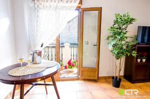 a dining room with a table and a door to a balcony at NATURAL ENVIRONMENT AND BEACHES-CTR in Valmaior +6 photos