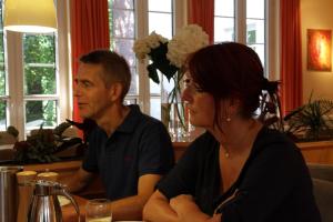 a man and a woman sitting at a table at Parkstadthotel Bad Muskau in Bad Muskau