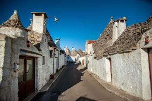 an alley in an old town with stone buildings at Amarcord casa vacanze in Alberobello