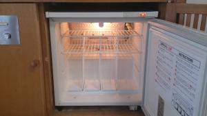 a small refrigerator with its door open with its door at Nagasaki IK Hotel in Nagasaki
