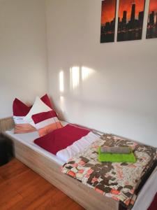 a bedroom with a bed with colorful pillows at Limonádé Apartman in Gárdony