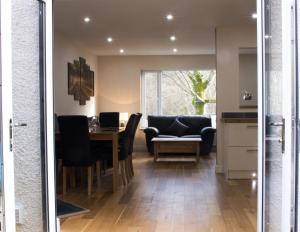 a kitchen and dining room with a table and chairs at 1 Balnakeil, Kirk Road in Oban