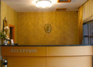 a reception desk with a reception sign on a wall at Pınar Elite Hotel in Adana