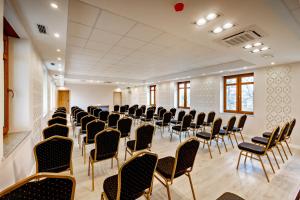 a room with rows of chairs in a room at Akacja Medical Resort in Ciechocinek