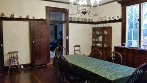 a dining room with a table and chairs and a chandelier at Mountain Home Bed & Breakfast in Front Royal