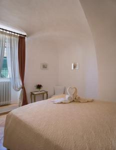 a bedroom with a bed with a towel on it at da Barbara in Orco Feglino