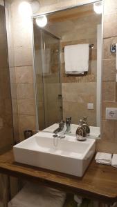 a bathroom with a white sink and a mirror at Las casas de Colinas in Vejer de la Frontera