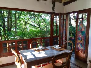 a dining room with a table and chairs on a balcony at Los Tarcos Guest House in San Salvador de Jujuy