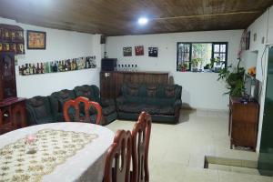 a living room with a table and a couch at HOSPEDAJE BELLA VISTA MONGUI in Monguí