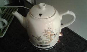 a white tea kettle sitting on a counter at Yellowunlimited Hotel in Kharkiv