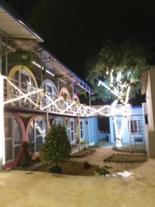 a building decorated with christmas lights at night at MŨM HOMESTAY MỘC CHÂU in Mộc Châu