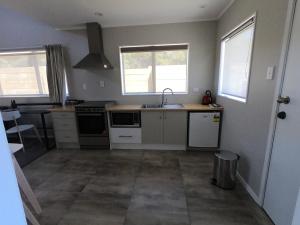 a kitchen with a sink and a stove at The Ohakune Central Motels in Ohakune