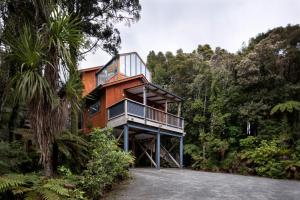 a house in the middle of a forest at Punakaiki Treehouse Limited in Punakaiki