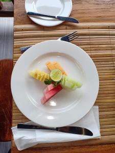 a plate of food with vegetables on a table at Batu Agung Villa Ubud in Ubud