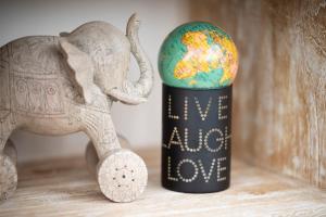 an elephant standing next to a cup with a globe in it at Love Punakaiki Luxury Couples Retreat Limited in Punakaiki