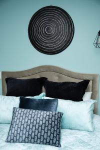 a room with a bed with black and white pillows at Love Punakaiki Luxury Couples Retreat Limited in Punakaiki