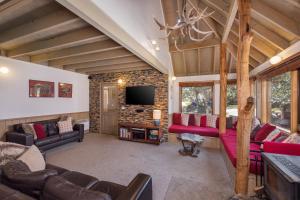 a living room with red couches and a tv at Burrinjuck in Dinner Plain