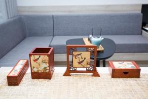 a group of boxes on a table with a couch at Atour Hotel Hangzhou Jinsha Lake in Hangzhou