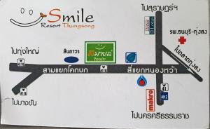 a close up of a sign with a smile on it at Smile Resort Thungsong in Thung Song