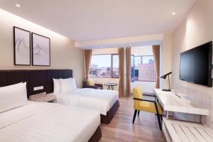 Postel nebo postele na pokoji v ubytování AIHO Hotel Medan