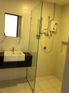 a bathroom with a sink and a glass shower at TREFOIL, WEE 816 STUDIO in Setia Alam