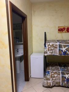 a room with a bed and a toilet at Airport Bedroom House in Catania