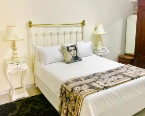 a white bed with a picture of a man on it at MiCasa SuCasa Manor in Pretoria