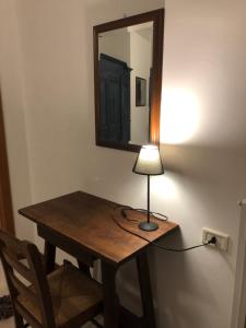a wooden table with a lamp on top of it at Ostello-Albergo dagli Elfi in Barrea