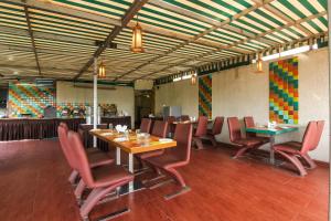 a dining room with tables and chairs and a bar at Hotel LXIA Hinjewadi - Indian Nationals Only in Pune