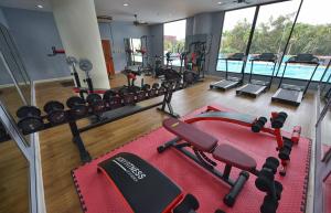 a gym with cardio equipment and a swimming pool at Loei Palace Hotel in Loei +31 photos