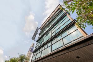 a building with a sign on the side of it at Hyde Park Hotel Bangkok in Bangkok