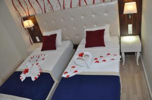 A bed or beds in a room at Kleopatra Micador Otel