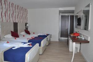 A bed or beds in a room at Kleopatra Micador Otel
