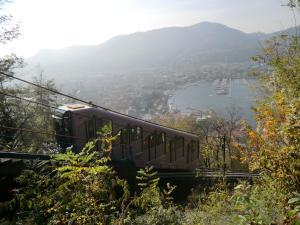a train on a suspension bridge over a lake at Via Funicolare in Brunate