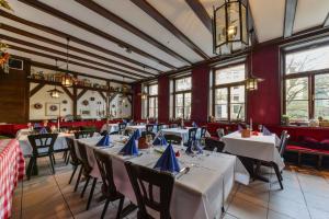 a dining room with white tables and chairs at Gasthaus Pillhofer in Nuremberg