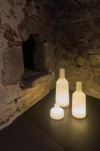 three white vases sitting in a cave at La Piconera (Petit Luxe) in Osor