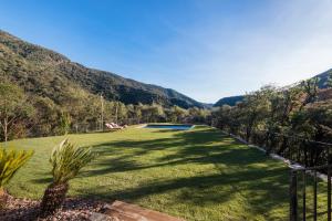 a grassy yard with a fence and a swimming pool at La Piconera (Petit Luxe) in Osor