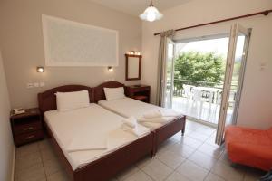 Postel nebo postele na pokoji v ubytování Hotel Afroditi